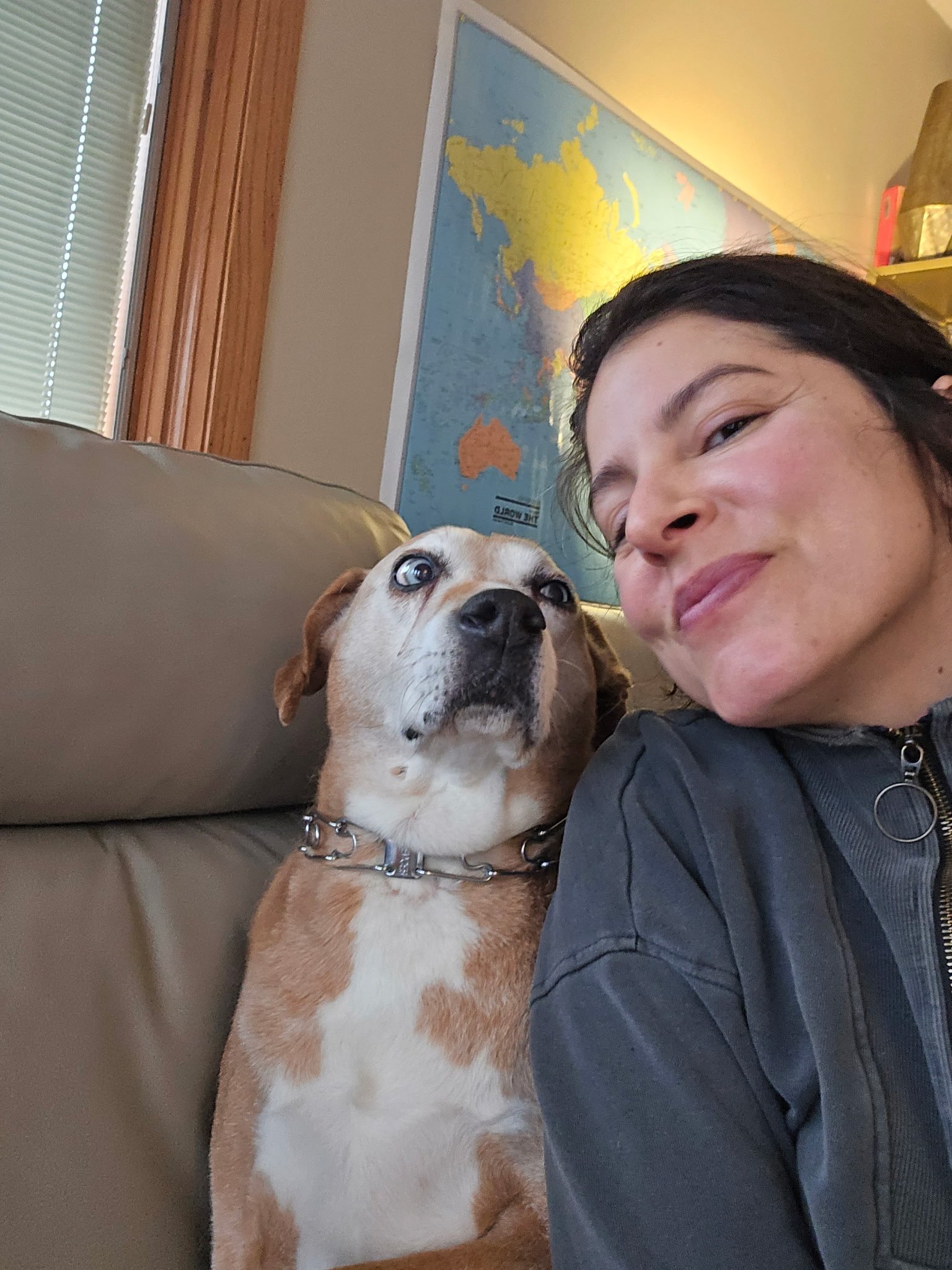 Dr. Emilia Ruiz, MD, owner of Royal You Med Spa in Madison, WI, relaxing at home with her dog